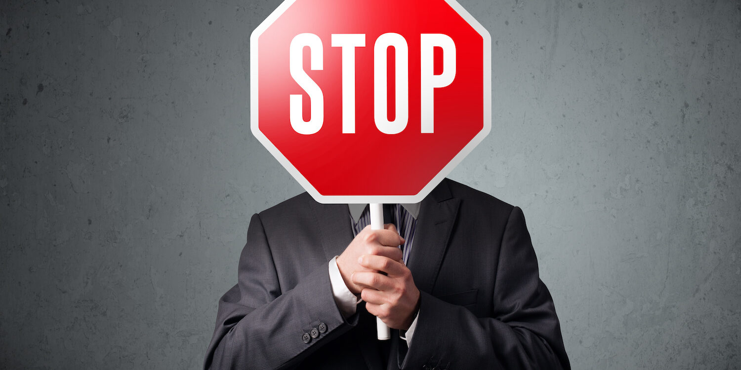 Businessman holding a stop sign