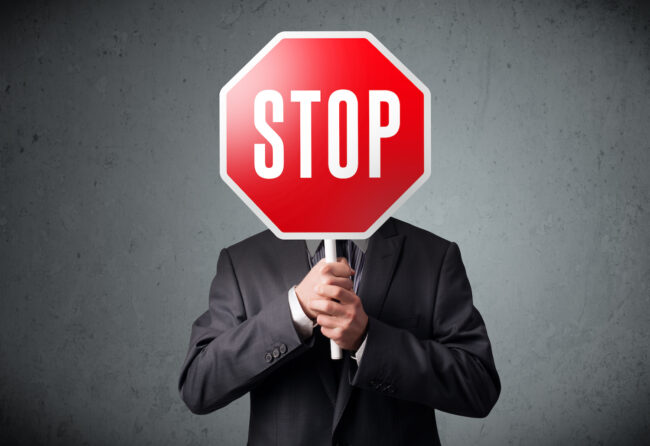 Businessman holding a stop sign