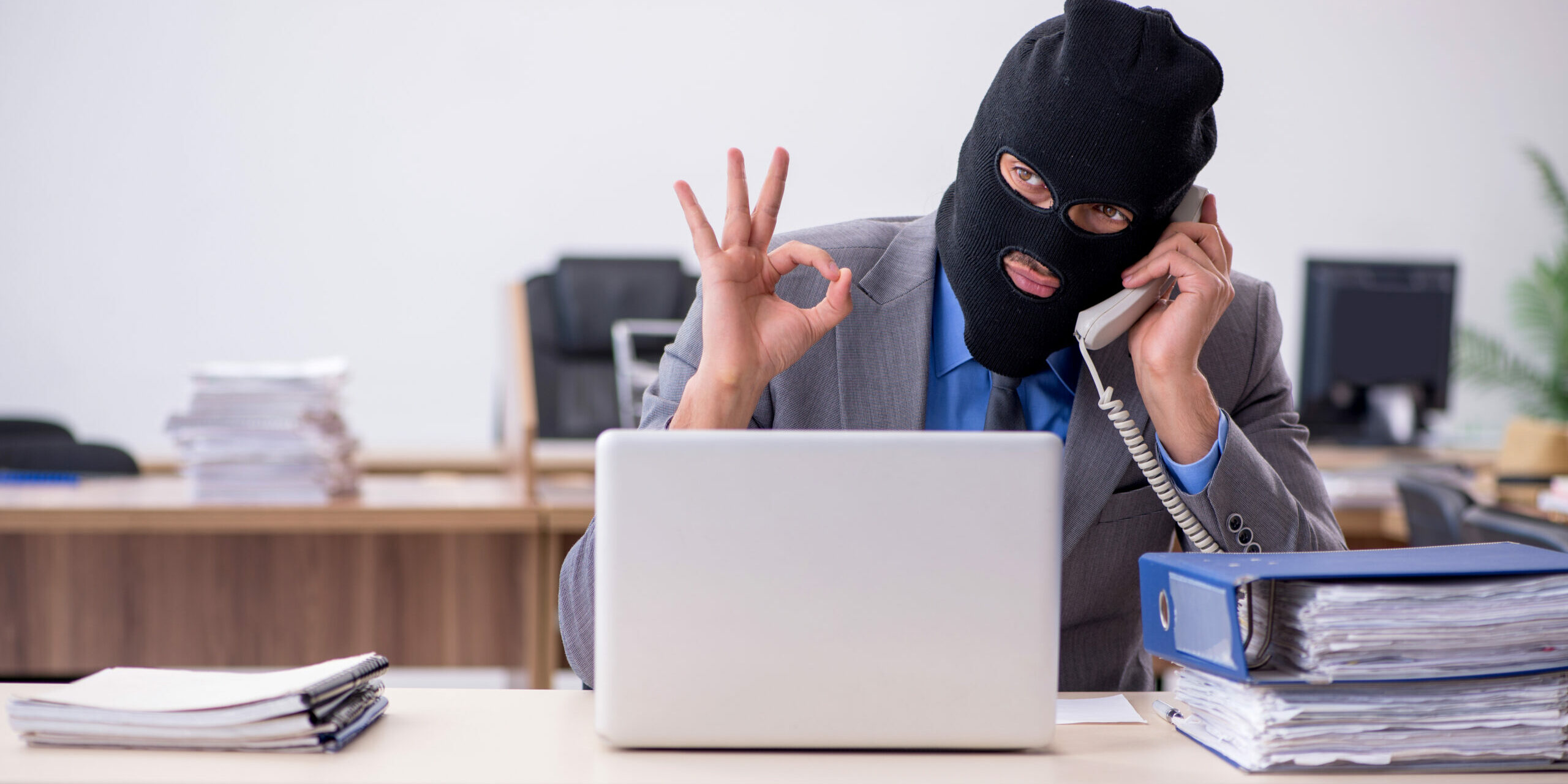 Young male employee in industrial espionage concept