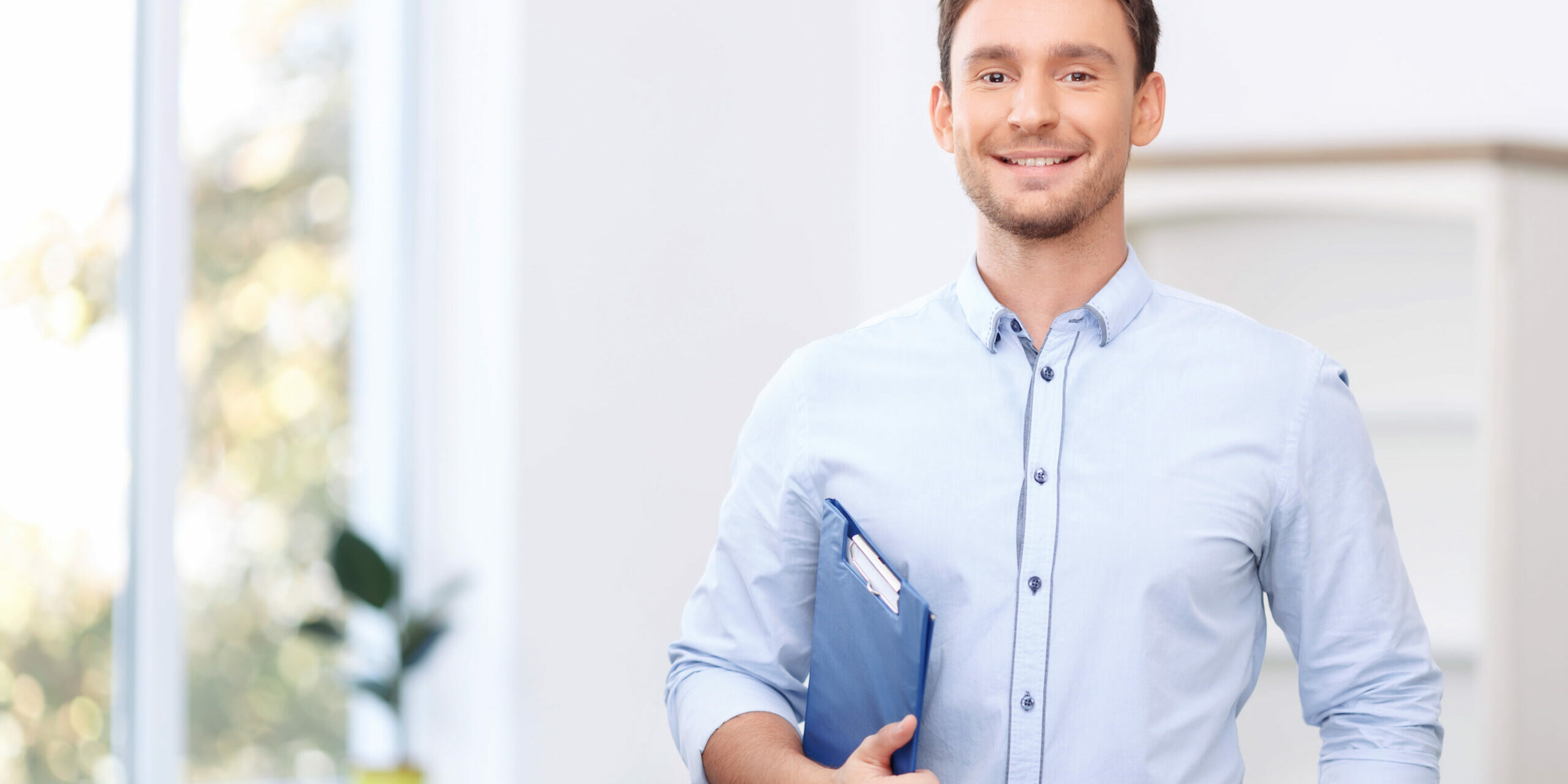 Nice realtor holding folder